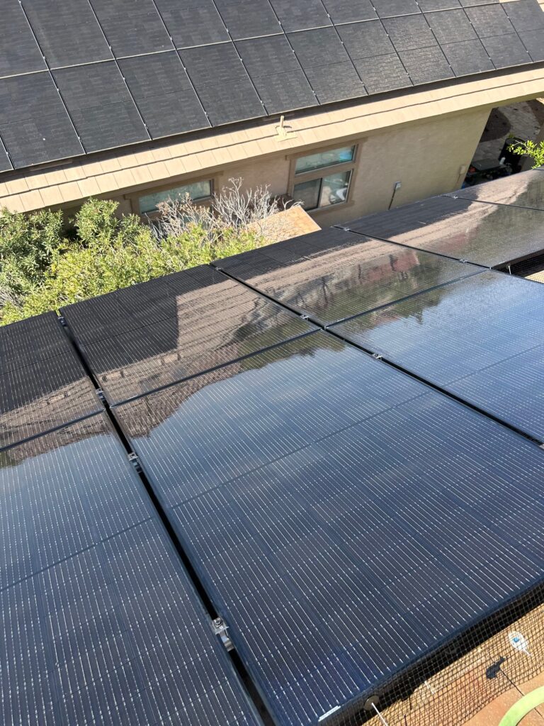 Solar Panel Cleaning-ScottsdaleAZ Rooftop Service - depalmasresidentialservices.com Technician using soft brush to clean solar panels on a home in Glendale, Arizona